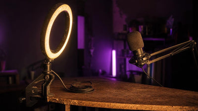 Ring light and condenser mic on a home desk, illustrating the setup cost debate in free vs paid stream overlays.