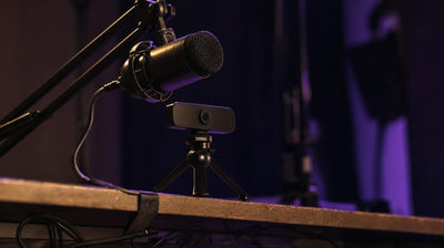 Desk mic arm angled over a small webcam, setup for a just chatting overlay stream.
